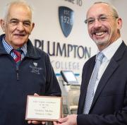 John Millen, sportsturf tutor at Plumpton College, left, accepts the award from David Cole, managing director of Reesink Turfcare
