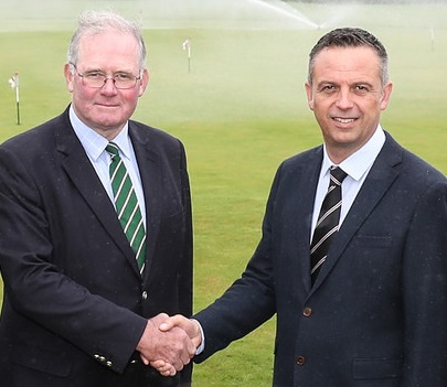 Royal St George’s chairman of greens Chris Healey (left) shakes hands with Reesink’s Robert Jackson