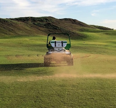 John Deere ProGator with spreader at work during the grow-in phase at Dumbarnie Links