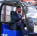 NI Economy Minister Simon Hamilton tests out Blaney Motor's new wheeled loader concept