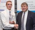 James Booth is presented with the AGCO Academy 2017 Apprentice of the Year Award by BAGMA director Keith Christian