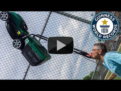 Farthest distance walked balancing a lawnmower on the chin (powered) - Guinness World Records