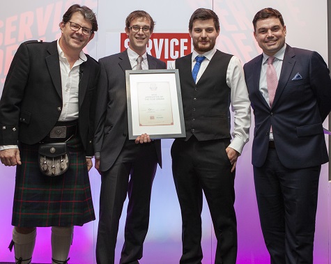 Martin Tyler, field service manager of Kubota UK, presenting the Apprentice of the Year award to William Dart of Hayes Garden Machinery & ATVs, with Service Dealer owner Duncan Murray-Clarke (l) and comedian Charlie Baker (r) at 2018's ceremony
