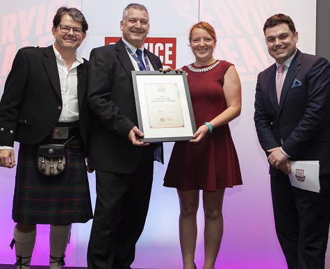 Mike Cameron, system sales manager for Catalyst, presents Jess Parks of AF Wiltshire with her Star Of The Dealership award, with Service Dealer owner Duncan Murray-Clarke (l) and comedian Charlie Baker (r) at 2018's ceremony