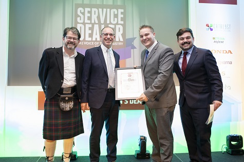 Adam Giles, Account Manager at Ibcos (second left) presenting the Forestry Equipment Dealer of the Year award at 2019's ceremony