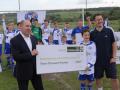 Briggs & Stratton's Ian Small presents the £3000 cheque to South Newton & Wishford FC's Harry and Paul Russell