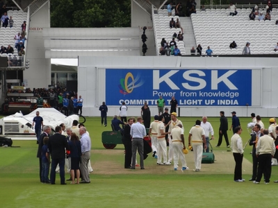 Mowing through the crowd, Mick negotiates players and the media ahead of the game