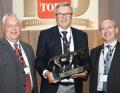 Graham Dale, Lely's managing director, accepts The Toro Company's annual Distributor of Excellence Award with Trevor Chard, Lely key account manager, on his left and David Cole, Lely turf division senior manager