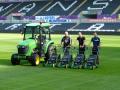 Swansea City FC grounds staff at the Liberty Stadium with the new John Deere 3720 compact tractor and cab, and four of the R54RKB walk-behind rotary mowers