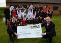 Ian Small of Briggs & Stratton (right) presents the £3000 to Clifford Juniors