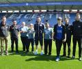 Leicester City FC head groundsman John Ledwidge (centre) with members of the IOG Young Board of Directors and some of the schoolchildren who attended the Schools into Stadia event at the King Power Stadium