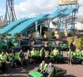 Thorpe Park Resort’s new John Deere fleet in front of the Depth Charge and Swarm rides, with the landscape team led by Ian Stanbridge (seated front left)