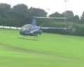 The helicopter hovering over the wet pitch
