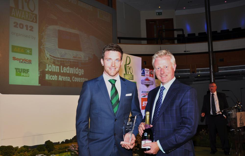John Ledwidge (left) head groundsman of the Ricoh Stadium, Coventry, receives his Turf Pro Young Turf Professional of the Year award from Richard Comely of Ransomes Jacobsen at Windsor