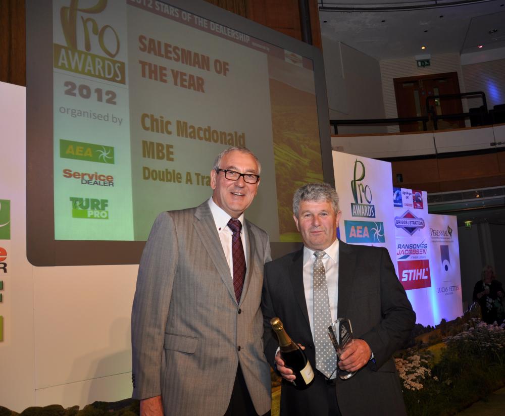 Chic Macdonald MBE of Double A Trading (right) collects his sales person of the year award from Luke Volknandt of Briggs and Stratton