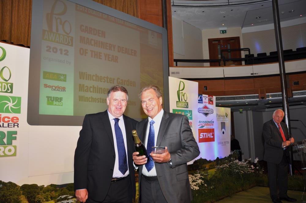 Robin Nettle of Winchester Garden Machinery collects his award from Sandy Brownlee of Lucas Fettes (left)