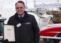 Andrew Rawson, Advertising and Promotions Manager, on the AGCO stand at LAMMA 13 with the certificate awarded for the Best Outdoor Stand at the event
