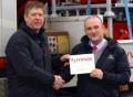 Trimax's Chris York (left) presents the company's outstanding sales achievement award to Eric Pattinson of Trimax dealer, Greenlay