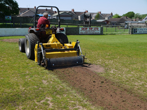 The BLEC Compact Multivator 1.5m in action on a football pitch during renovation