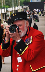 A Chelsea Pensioner takes a picture of Zara Phillips