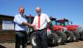 Tim Lawrence (right), AgriArgo UK area sales manager, welcomes Charlie Rollason to the McCormick tractor sales and service support network.