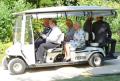 The Queen, Prince of Wales and the Duchess of Cornwall pictured travelling around the grounds of Buckingham Palace at the Coronation Festival to celebrate her 60-year reign. The E-Z-GO 6-Shuttle is similar to the fleet supplied to transport visitors at last year's Olympic Games