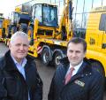 JCB CEO Graeme Macdonald, right, and Andy Walder of the Construction Industry Training Board, see the JCB machines on their way to UK flood disaster zones yesterday