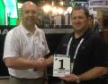 Sandy Armit of Double A (l) is presented with the UK dealer award by Ryan Wood of Dakota