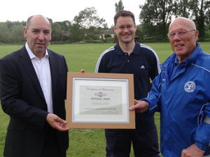 Ian Small presents a framed certificate to South Newton & Wishford's Assistant Coach Paul Russell and Chairman Mike Plowman