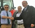 Tim Lawrence of AgriArgo welcomes Roger (left) and Jonathan Pearson to the McCormick sales and service dealer network at the Lincolnshire Show