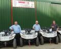 Gordon Agri staff with the ATVs which were specially painted white to be in keeping with international peace keeping and support vehicles