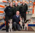 Fraser Robb with three of the Trossachs Search and Rescue team and their dogs
