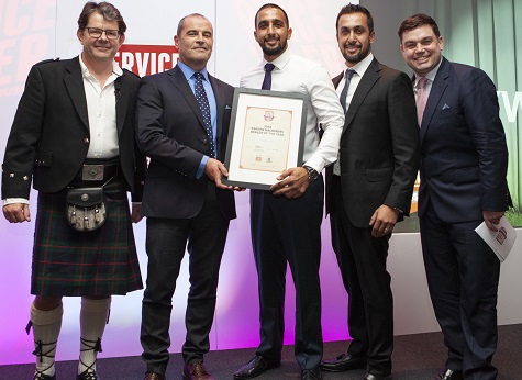 Ken Brewster, Husqvarna UK Sales & Marketing Director presenting the Garden Machinery Dealer of the Year award to Amar and Rajiv Parmar of Gayways with Service Dealer owner Duncan Murray-Clarke (l) and comedian Charlie Baker (r) at 2018's ceremony