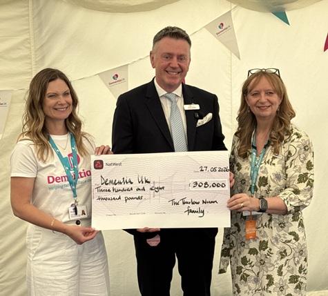 James Thurlow presenting a cheque to Sarah Child and Caroline Scates of Dementia UK
